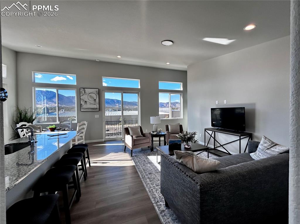 Living area with dark wood finished floors and recessed lighting