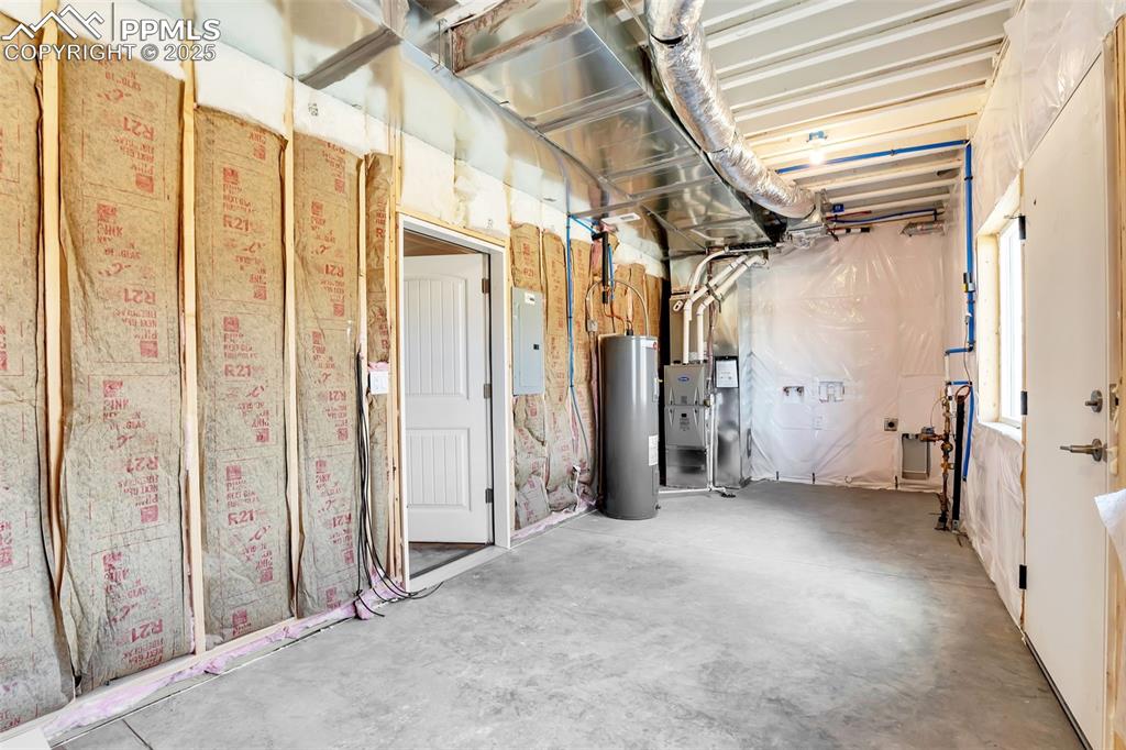 Unfinished mechanical and laundry off of garage.