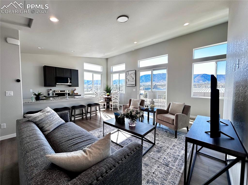 Living room featuring dark wood-type flooring and recessed lighting