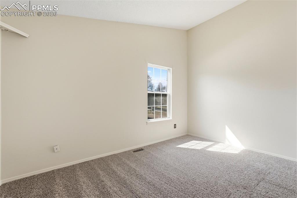 Unfurnished room with carpet and baseboards
