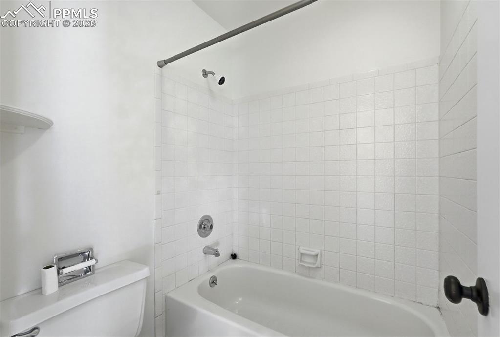 Full bath featuring toilet and bathtub / shower combination