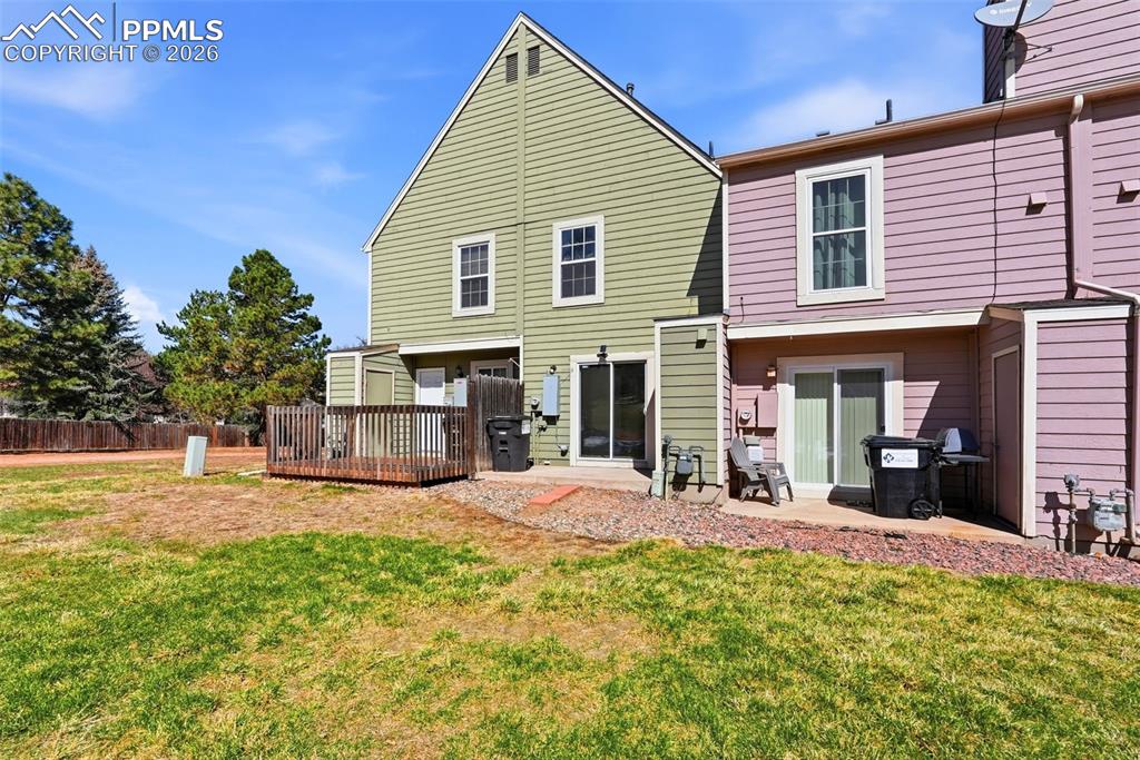 Rear view of house featuring a patio area and a deck