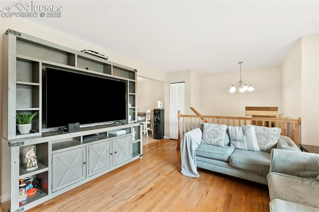 Living area with a chandelier and light wood-style floors