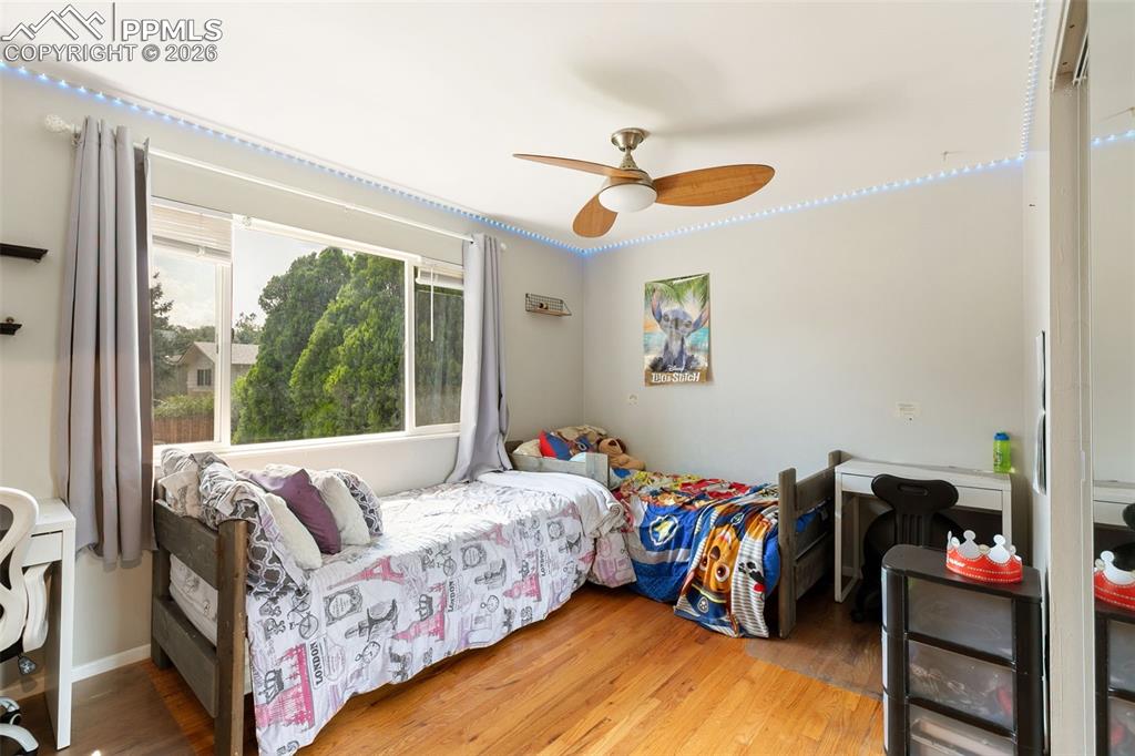 Bedroom featuring wood finished floors and ceiling fan