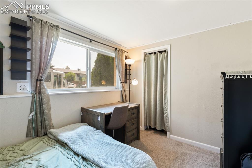 Carpeted bedroom featuring baseboards and ornamental molding
