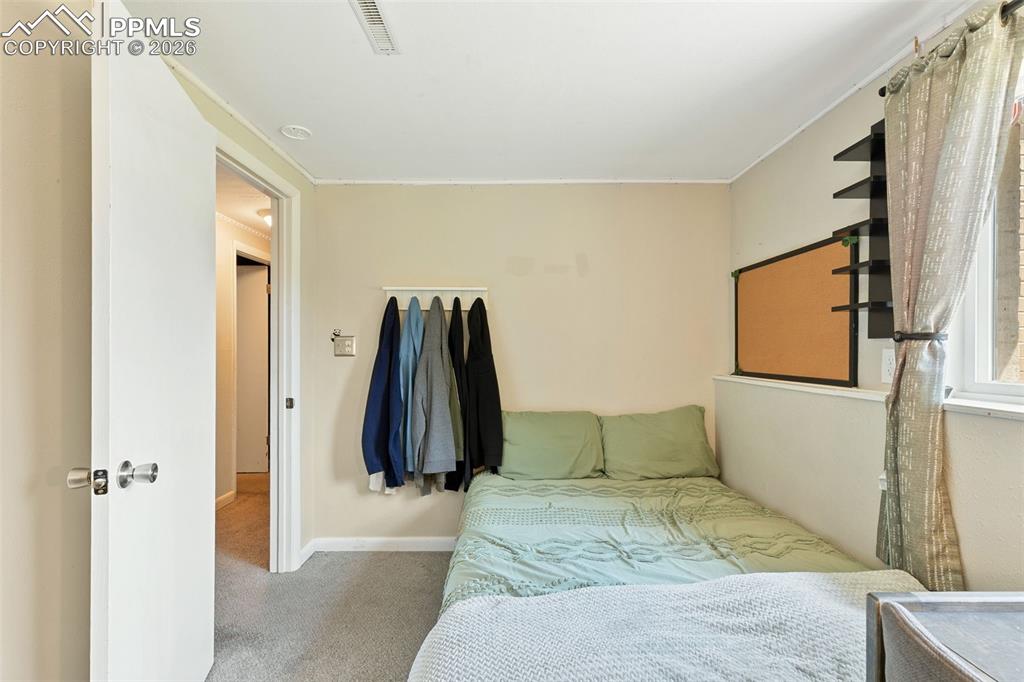 Carpeted bedroom featuring baseboards