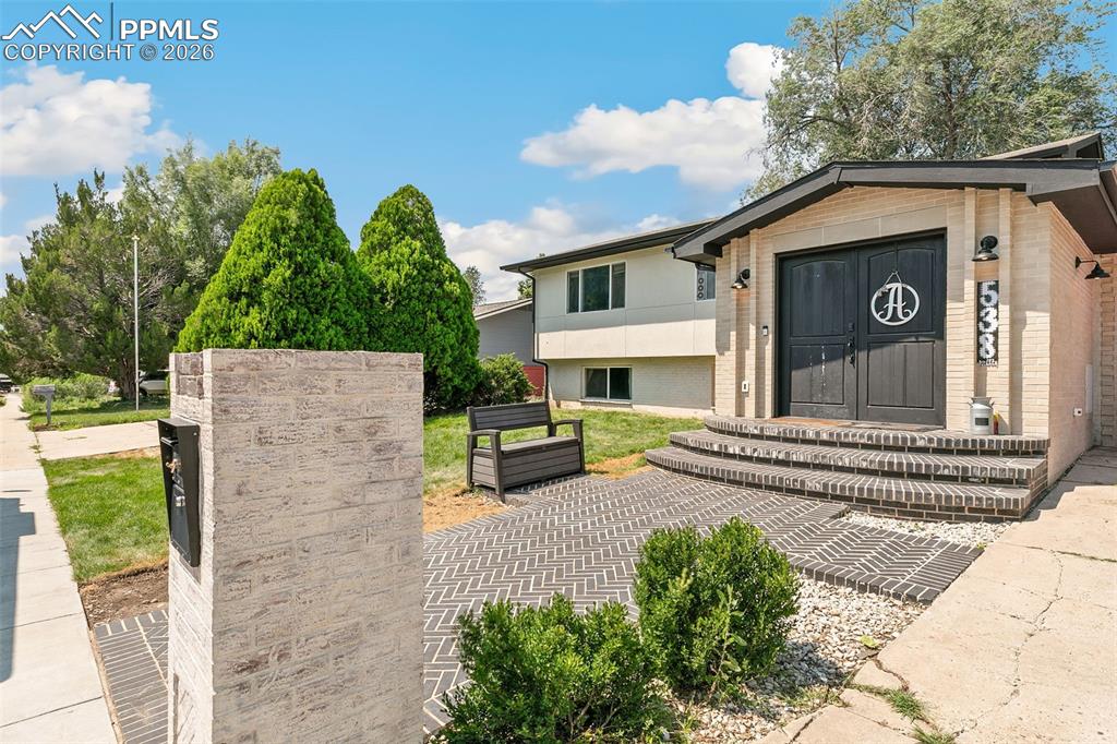 View of front of house featuring brick siding