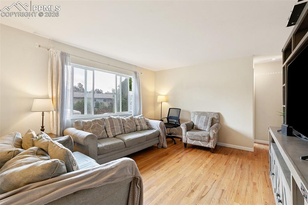 Living room featuring light wood finished floors and baseboards