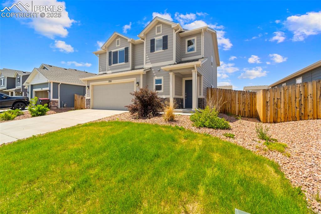 View of front of house with a garage and concrete driveway