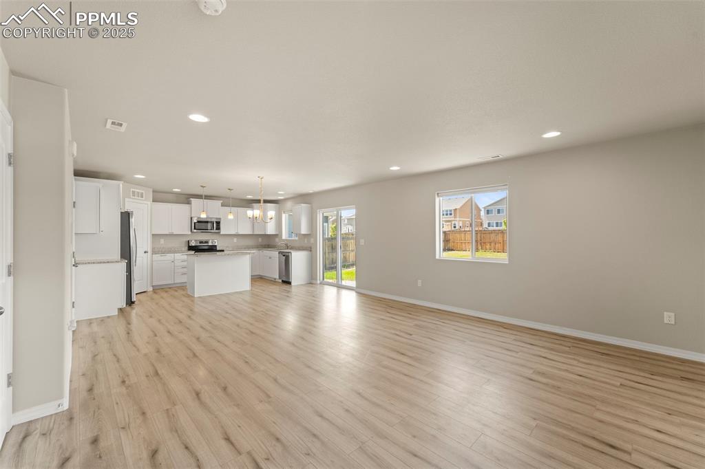 Unfurnished living room with recessed lighting and light wood-type flooring