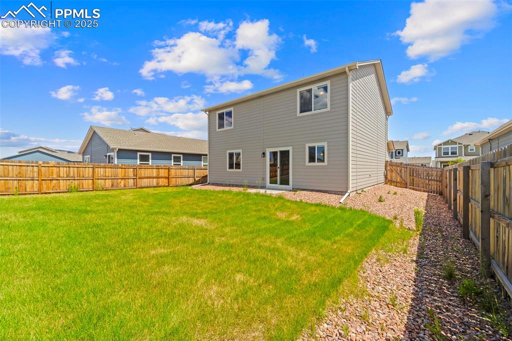 Back of house featuring a fenced backyard