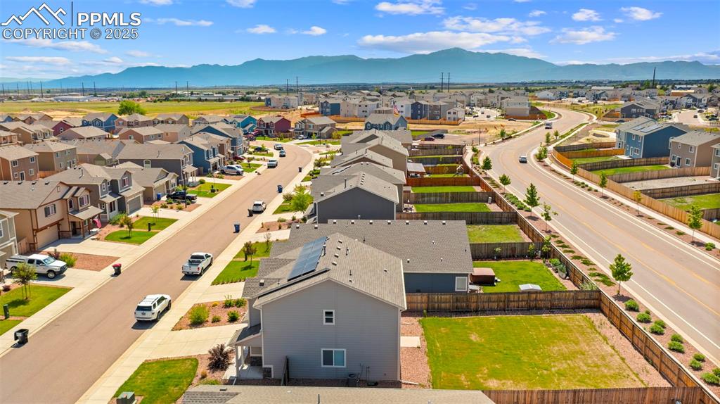 Aerial perspective of suburban area featuring a mountainous background