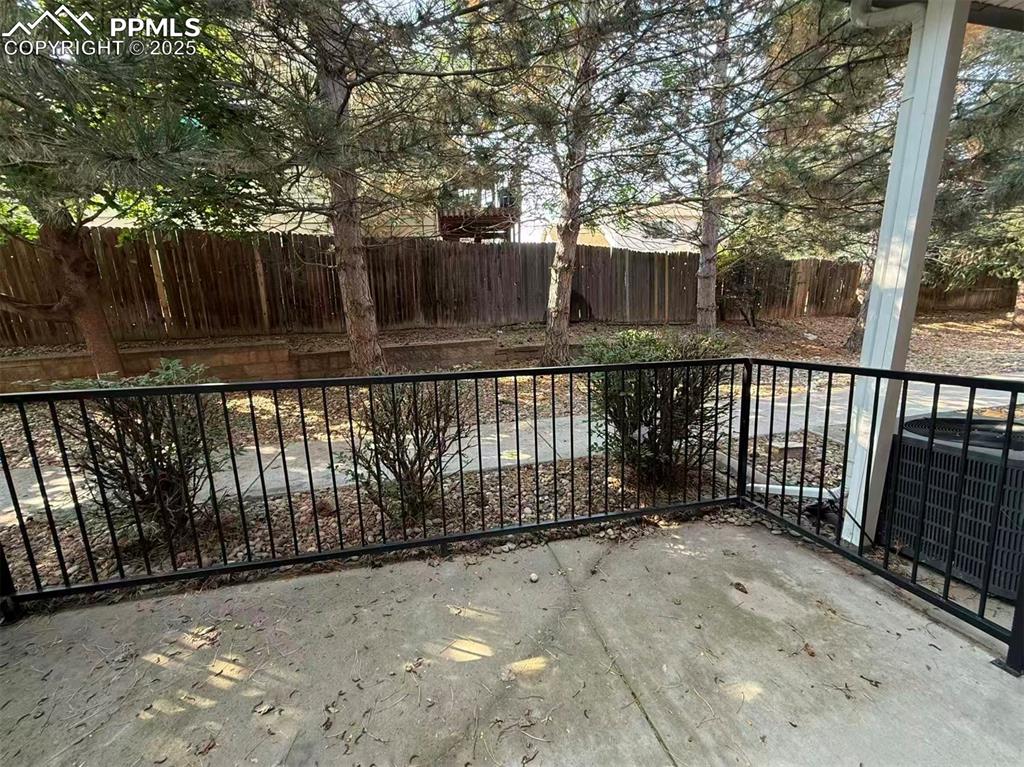Gate featuring a fenced backyard and a patio