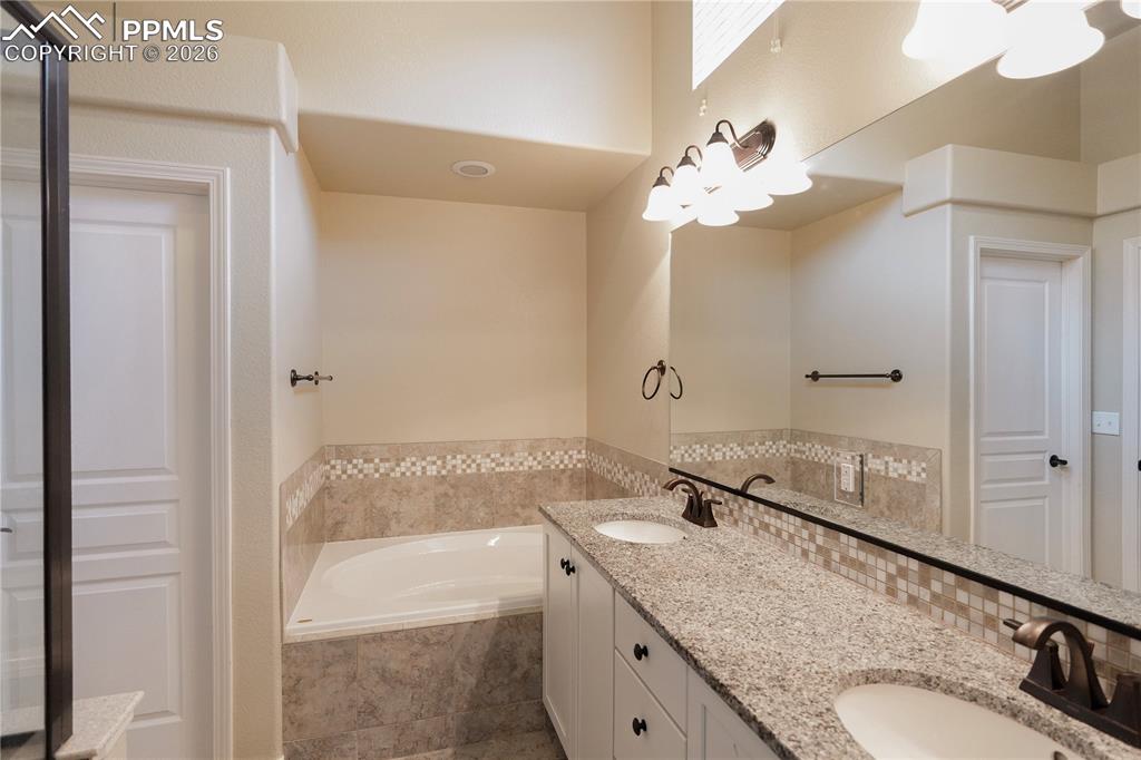 Bathroom featuring double vanity and a bath