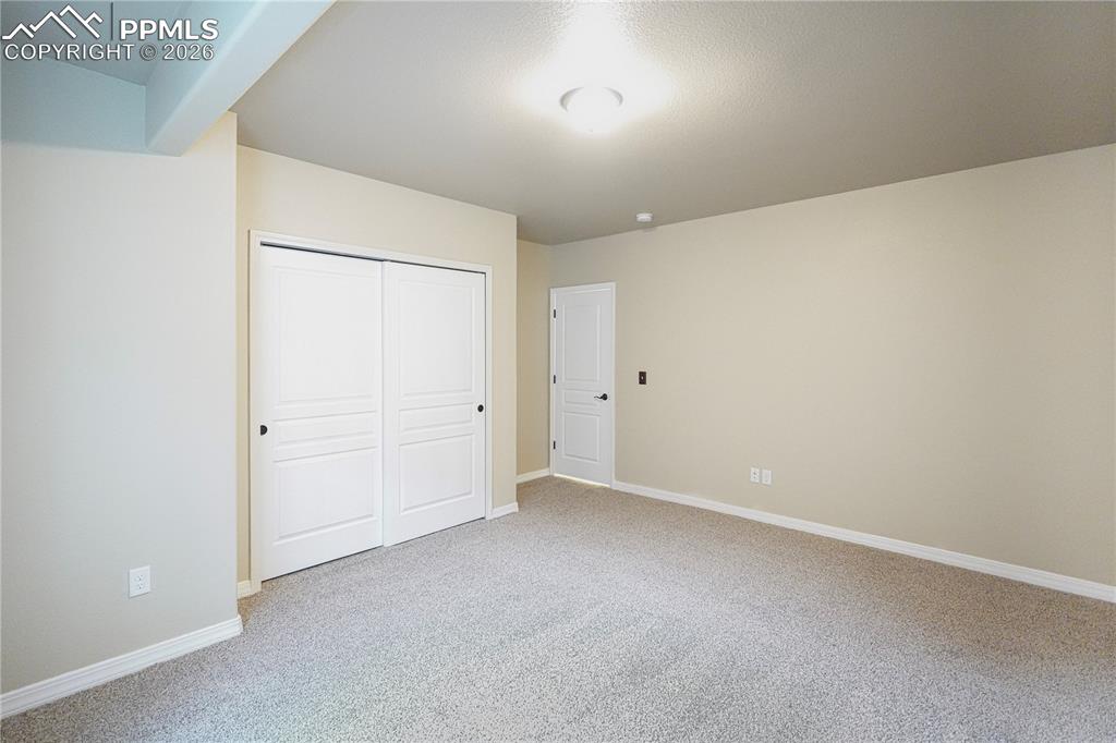 Unfurnished bedroom with a closet and light colored carpet
