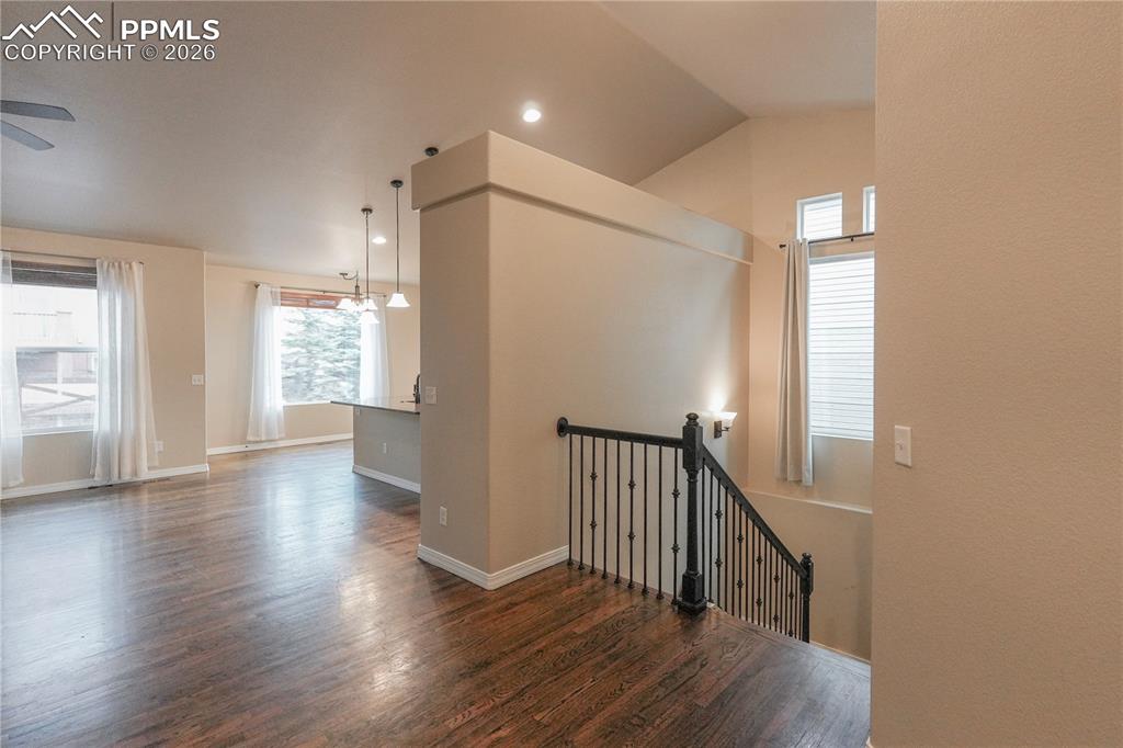 Stairway with wood finished floors and recessed lighting