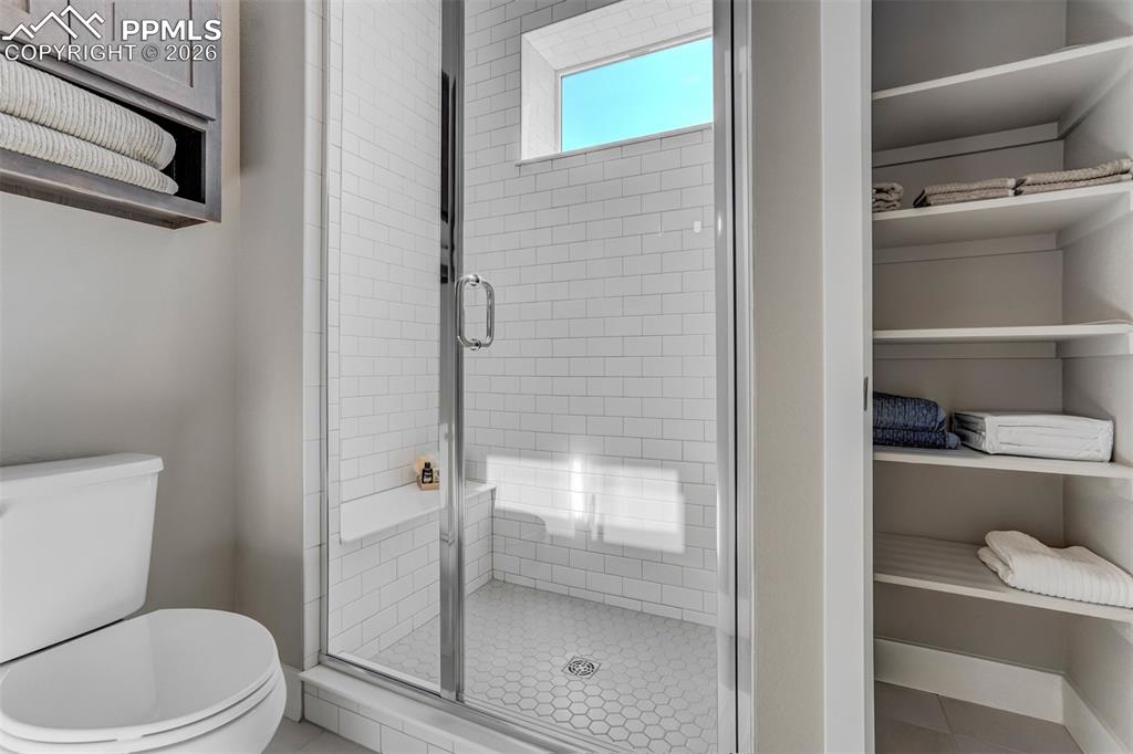 Bathroom with a stall shower and toilet