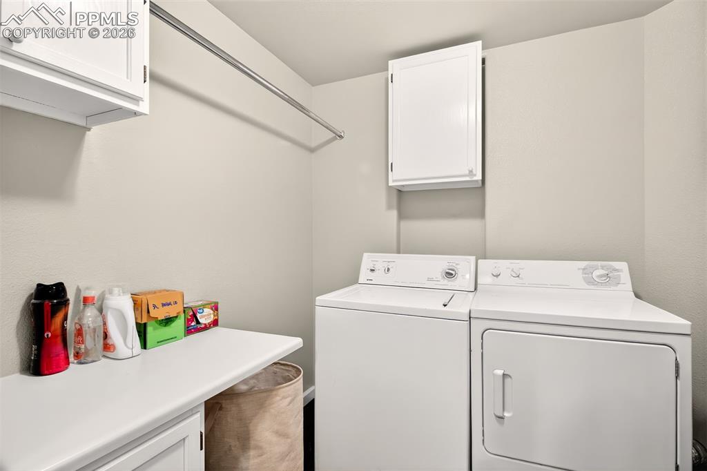 large 8 x 8 laundry with cabinets and hanging rod