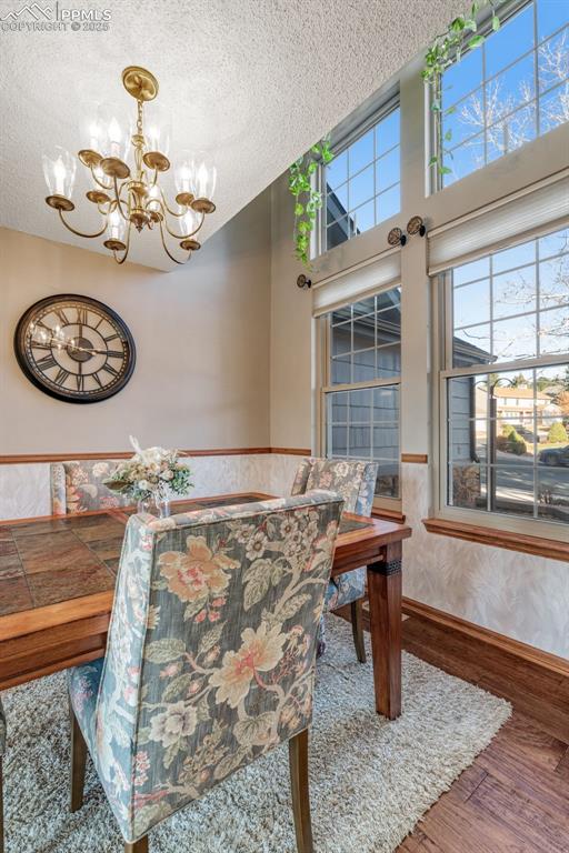 Dining room drawing light from 2-story windows. 
