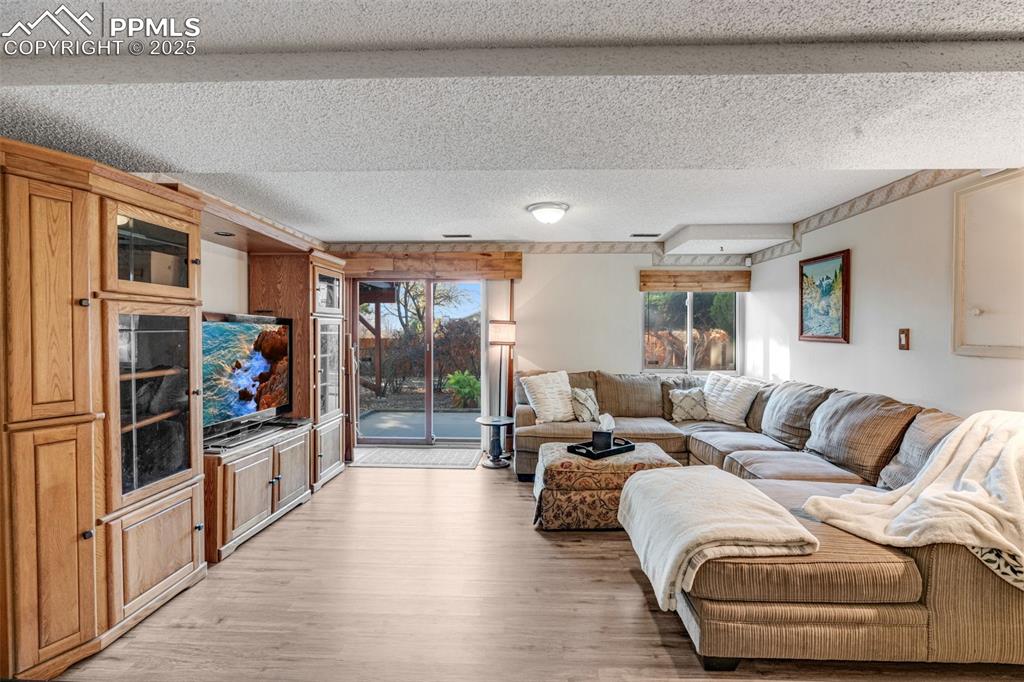 Living room featuring a walkout patio to beautifully landscaped backyard. 