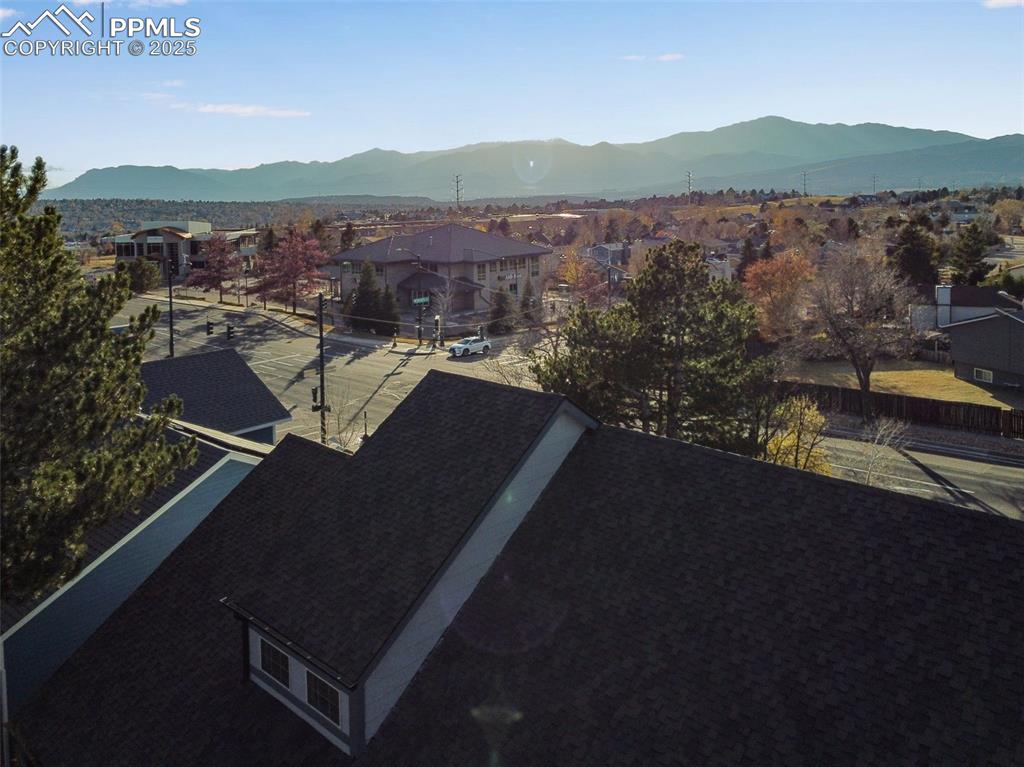 View of mountain backdrop featuring nearby suburban area