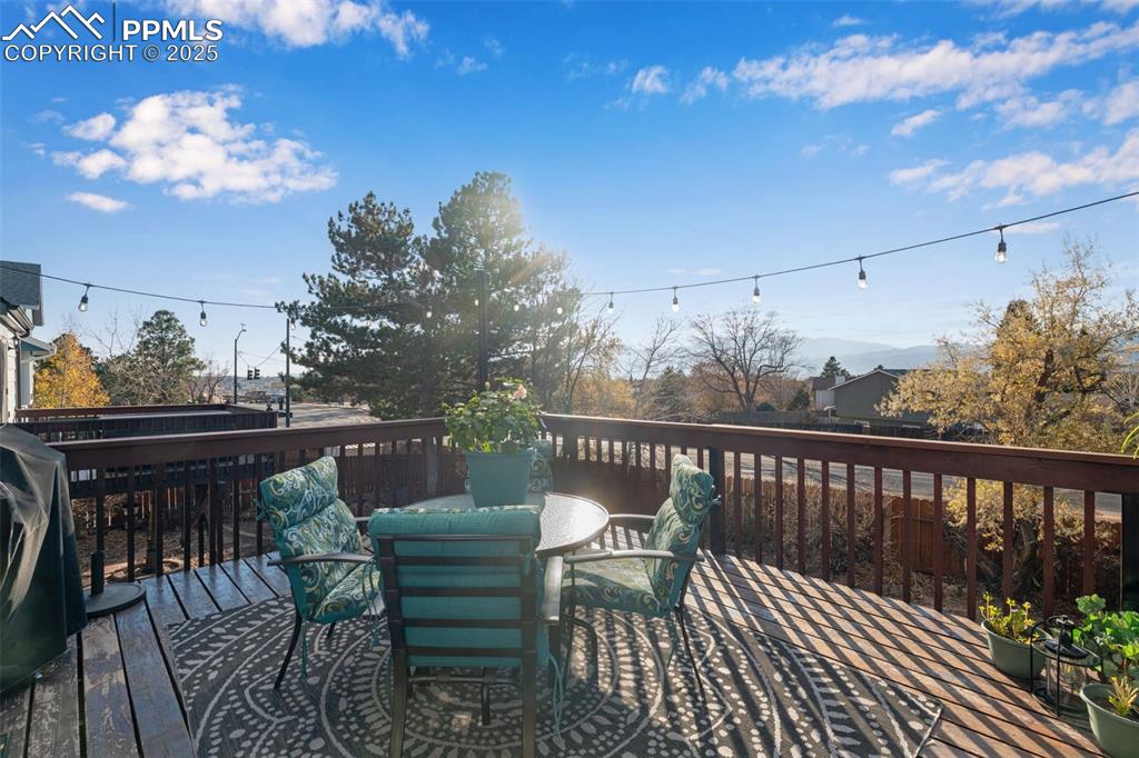 Wood deck featuring outdoor dining space and incredible views of Pikes Peak.