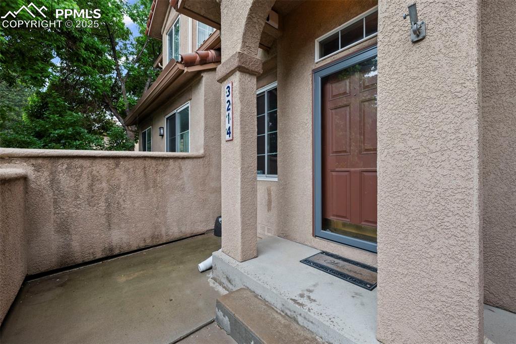 Property entrance with stucco siding