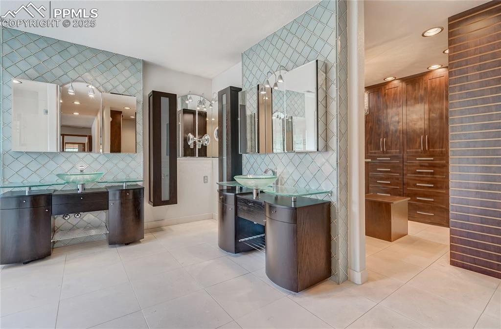 Bathroom with decorative backsplash, light tile patterned flooring, and recessed lighting