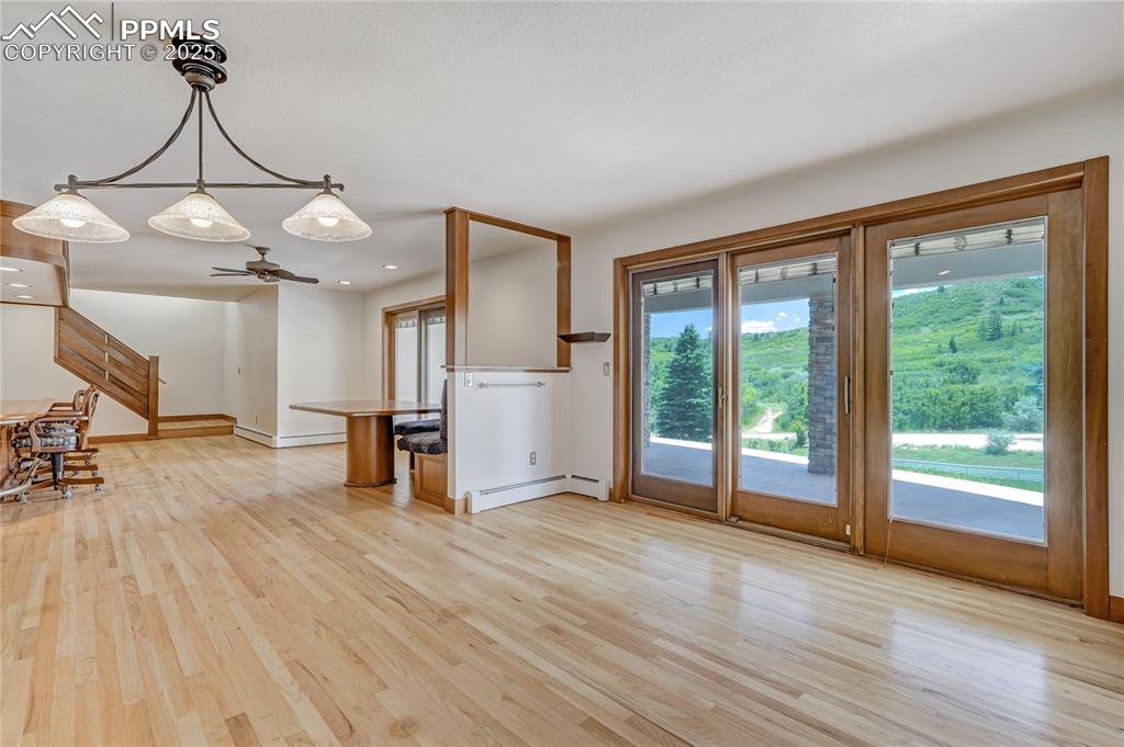 Unfurnished living room with light wood-type flooring, a baseboard heating unit, recessed lighting, a baseboard radiator, and a ceiling fan