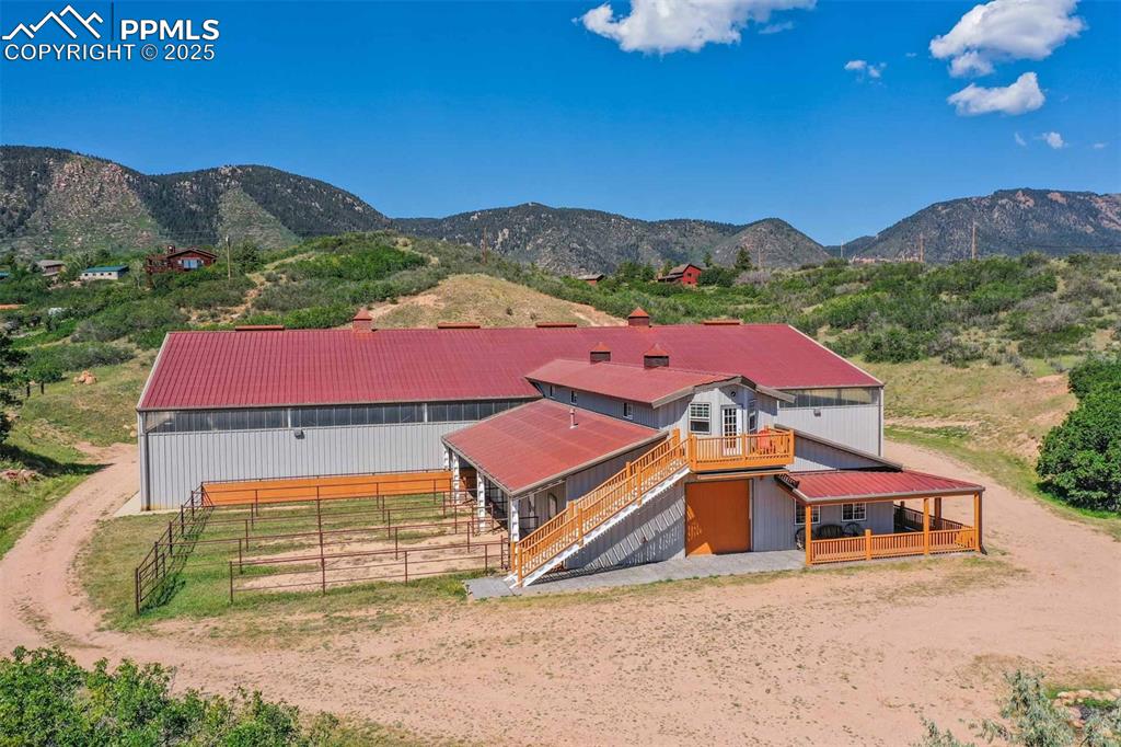 Aerial view of property and surrounding area featuring a mountain backdrop