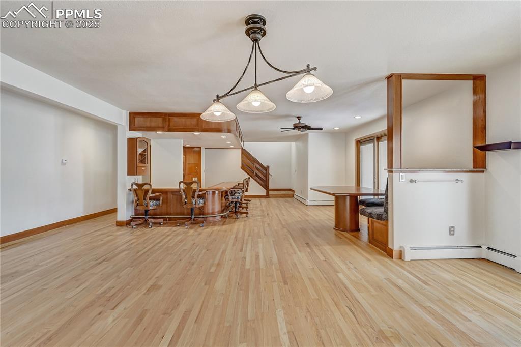 Kitchen featuring light wood-style floors, hanging light fixtures, brown cabinetry, recessed lighting, and ceiling fan