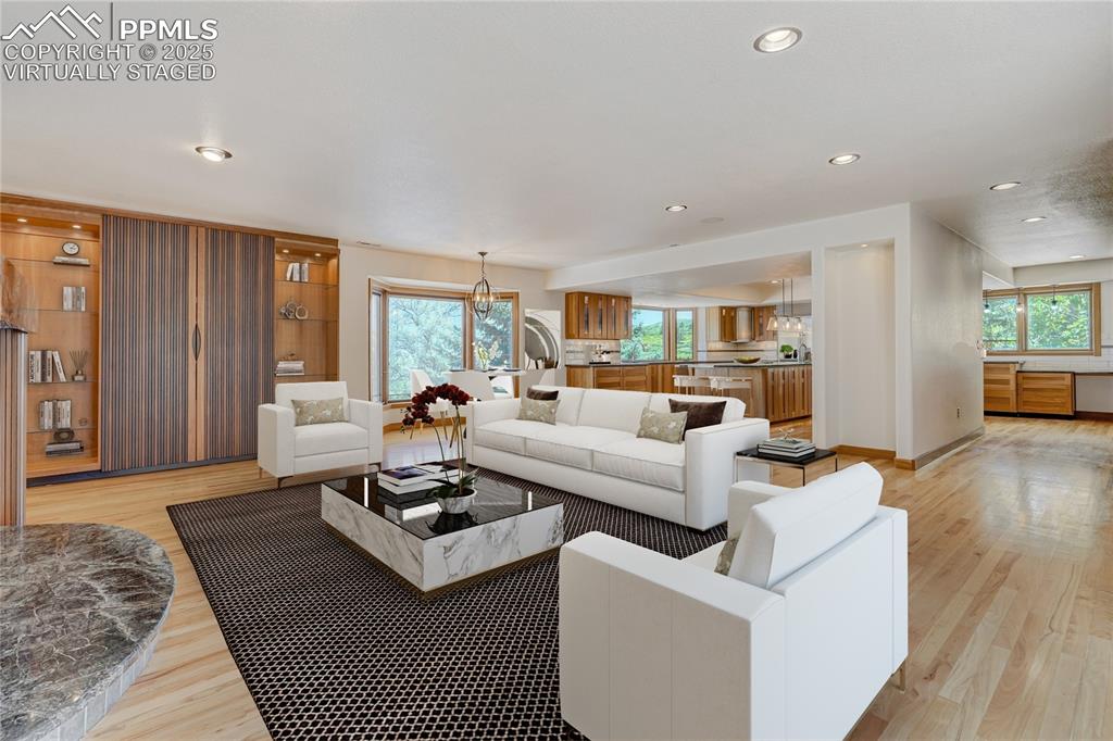 Living area with light wood-type flooring, virtually staged recessed lighting, and healthy amount of natural light