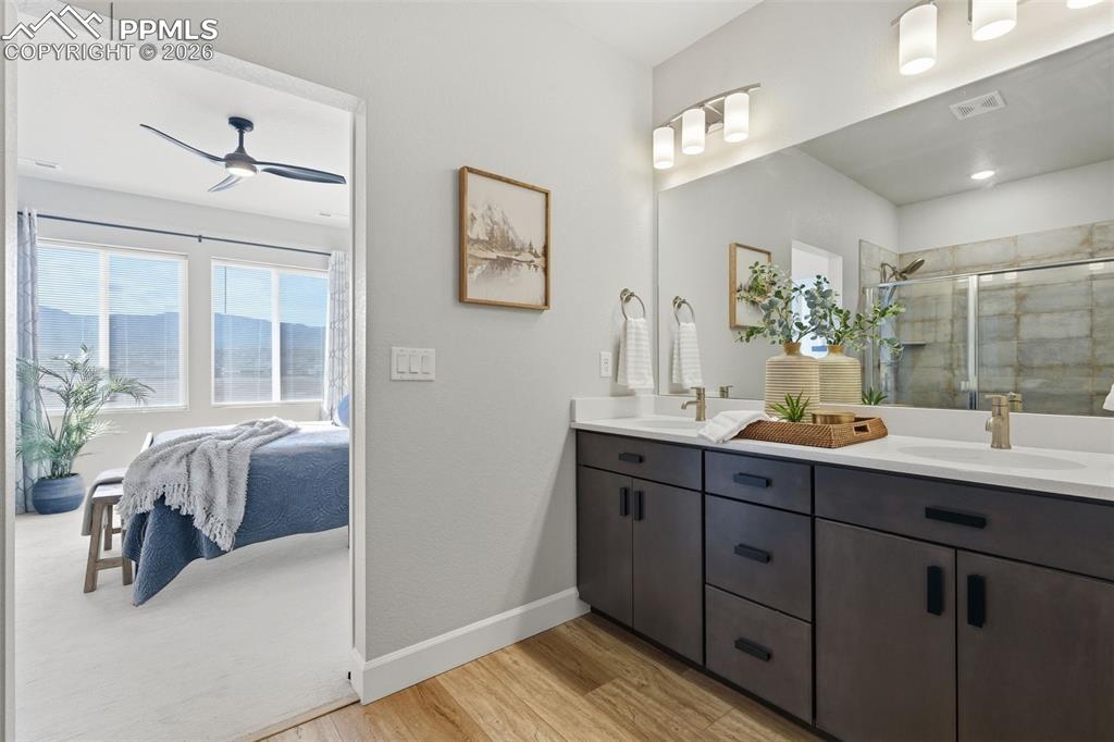 Ensuite bathroom with double vanity, upgraded shower and wood laminate flooring with walk-in closet makes everyday feel like spa-living 