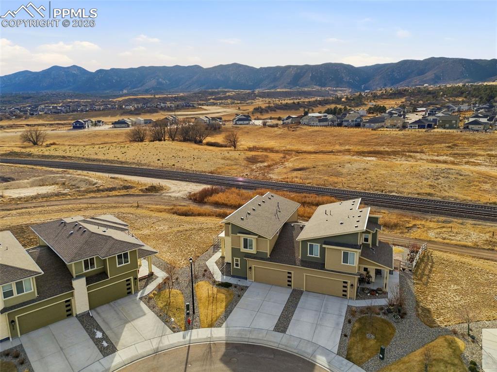 Aerial perspective of suburban area featuring a mountainous background