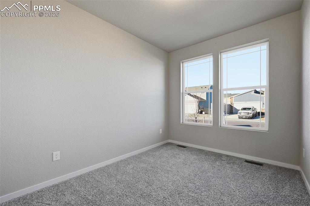 Unfurnished room with carpet and baseboards