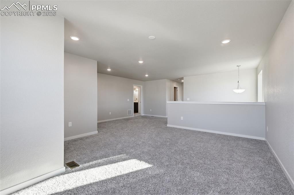 Spare room with light carpet and recessed lighting