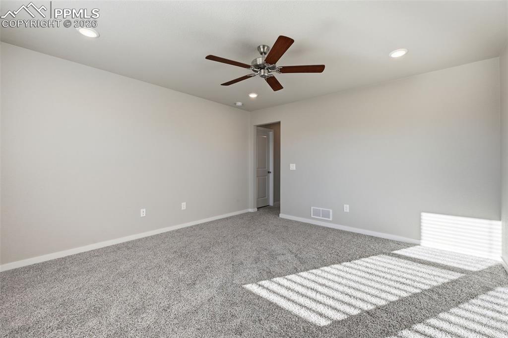 Empty room with carpet floors, recessed lighting, and a ceiling fan