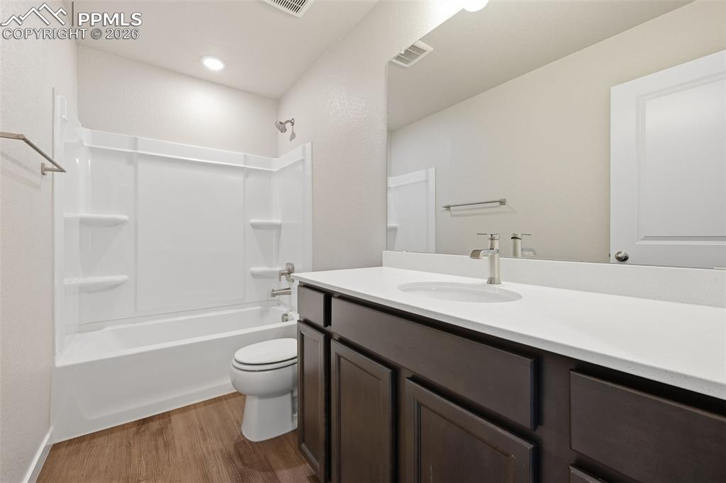 Full bathroom featuring vanity, light wood-style flooring, and shower / bathtub combination