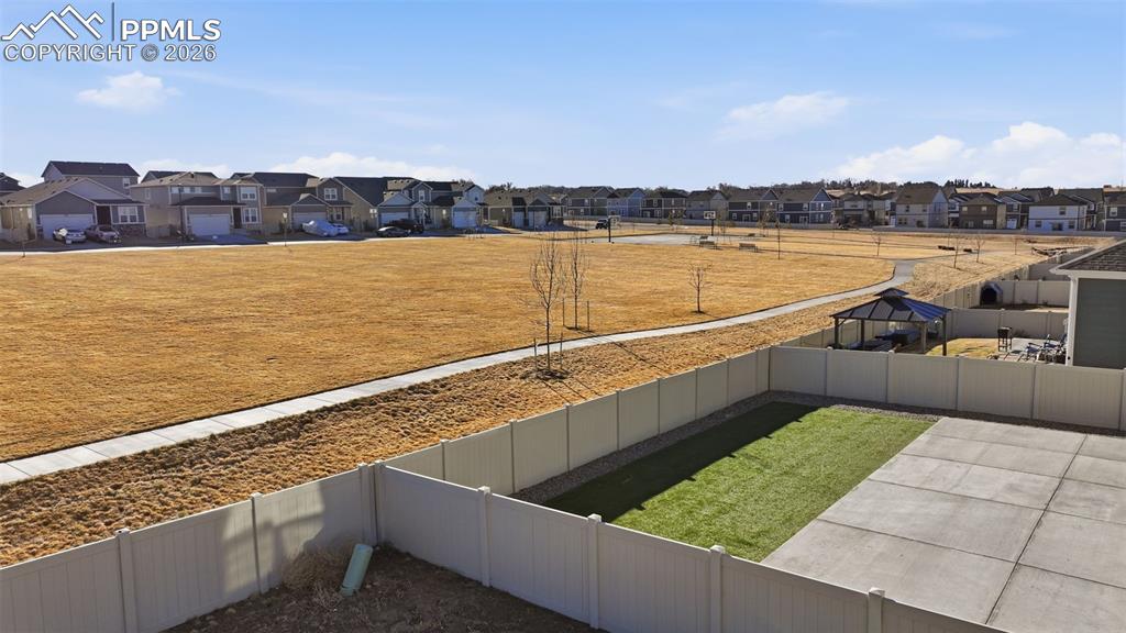Fenced backyard with a residential view