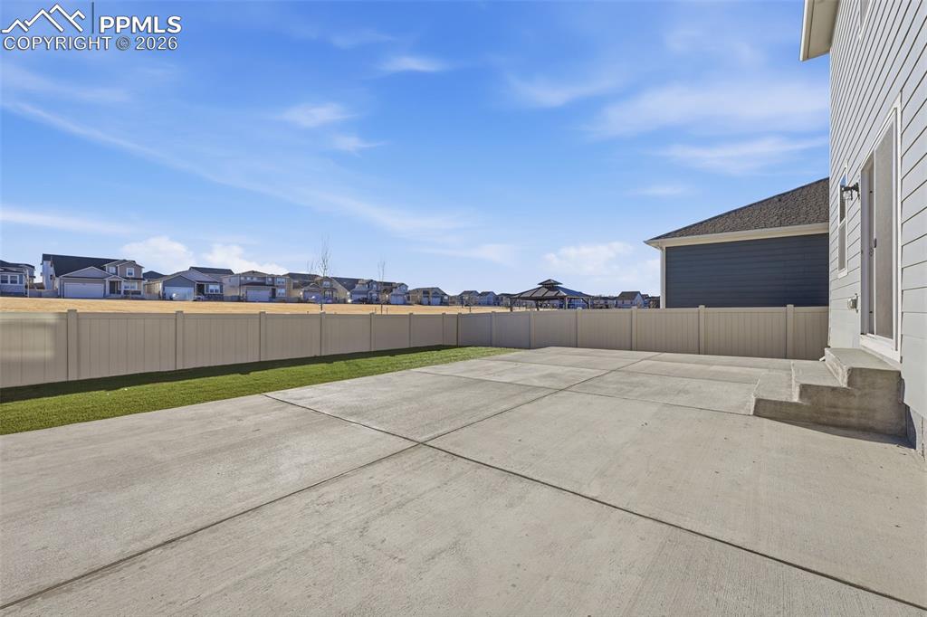 Fenced backyard with a residential view and a patio