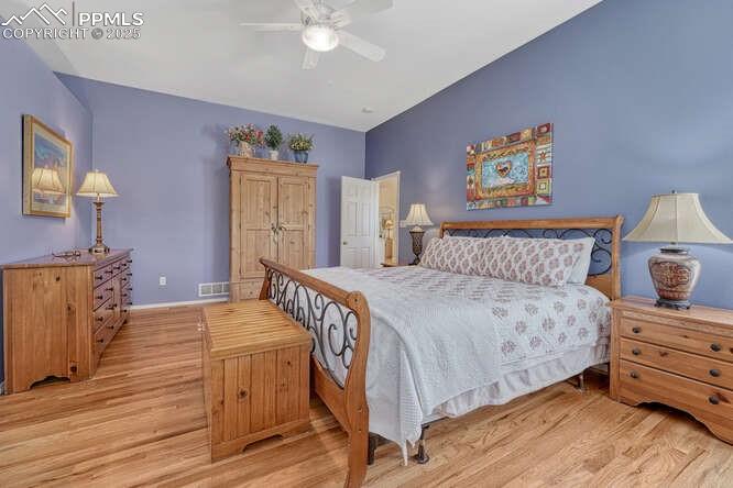 Bedroom with  wood floors and a ceiling fan