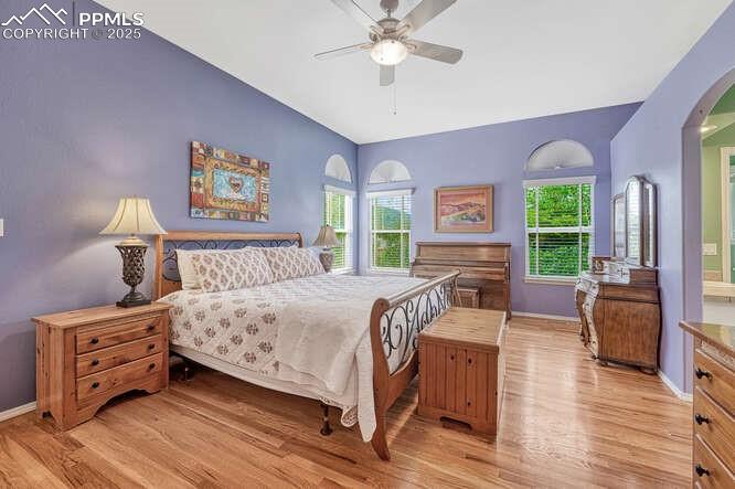 Bedroom with  wood floors and a ceiling fan