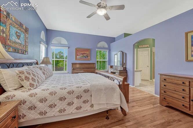 Bedroom with  wood floors and a ceiling fan
