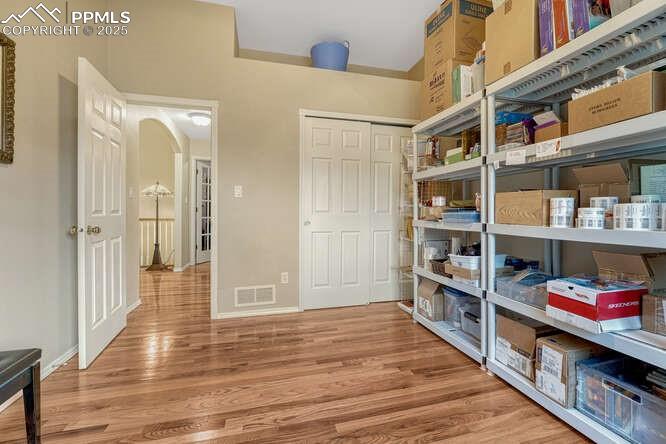Main level bedroom currently used for work storage