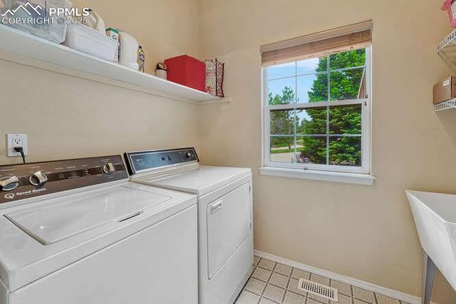 Main level Laundry featuring utility sink