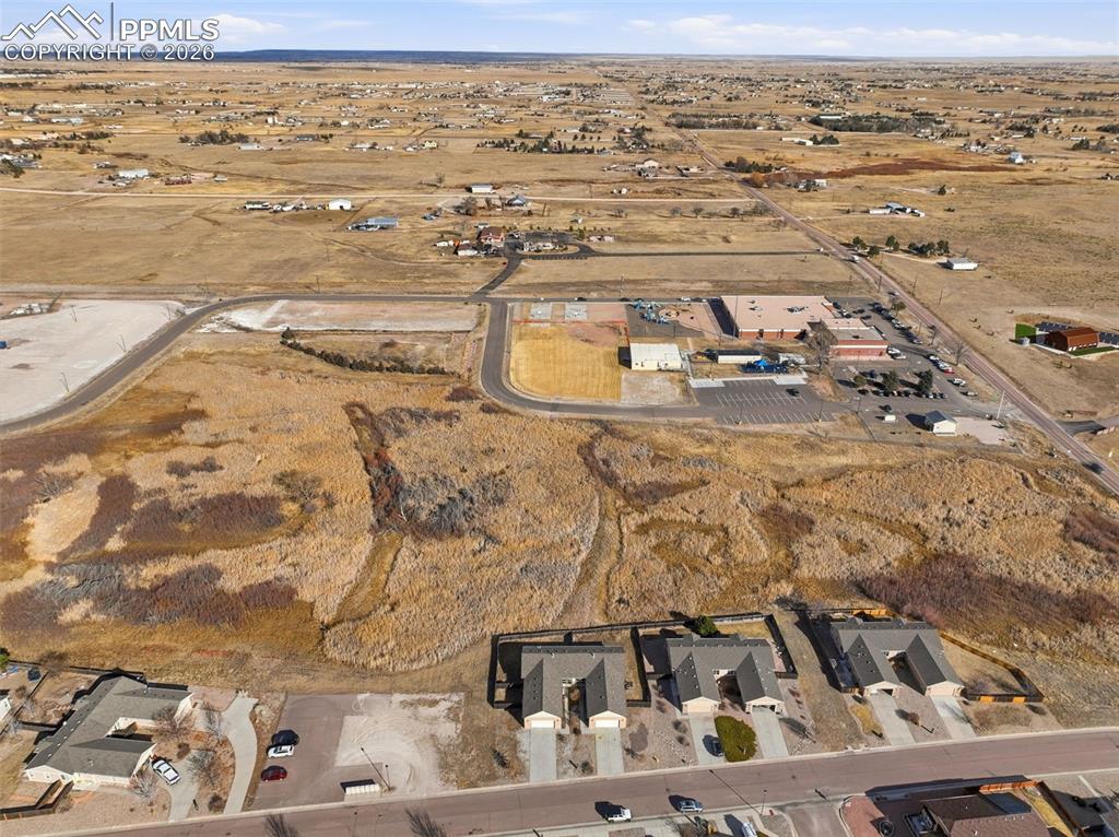 Aerial overview of property's location with nearby suburban area and rural landscape