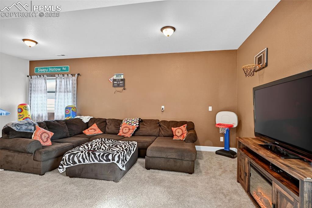 Carpeted living area featuring baseboards