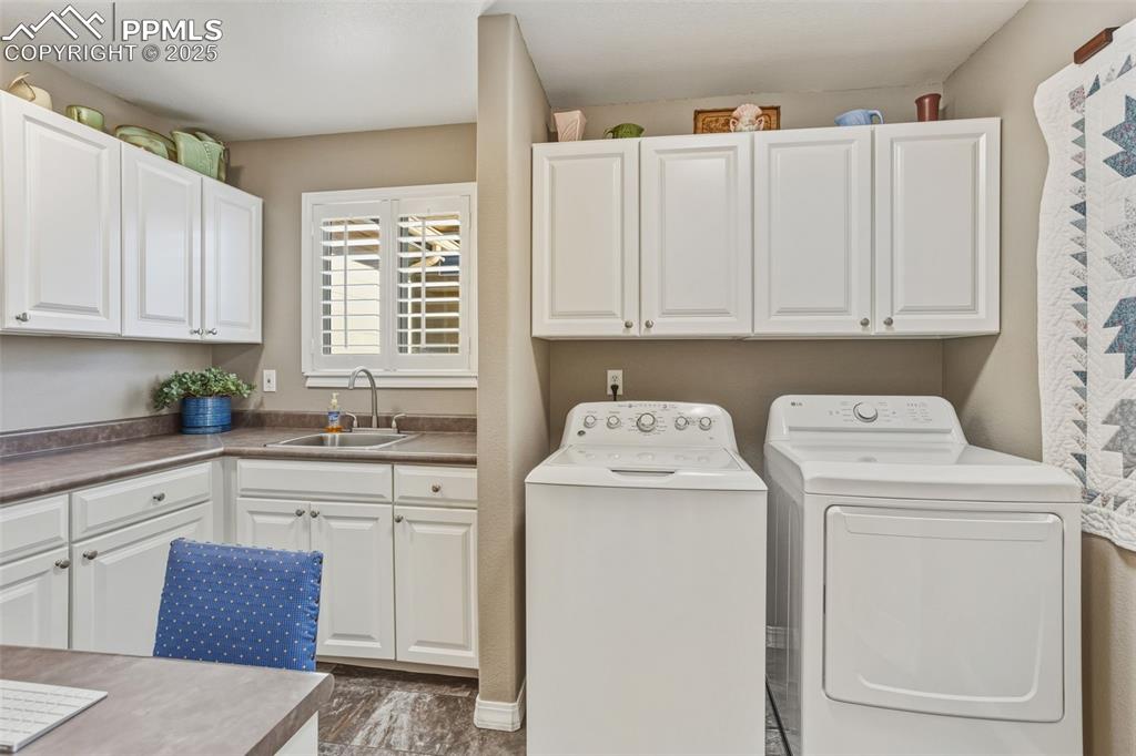 Laundry area featuring cabinet space and separate washer and dryer