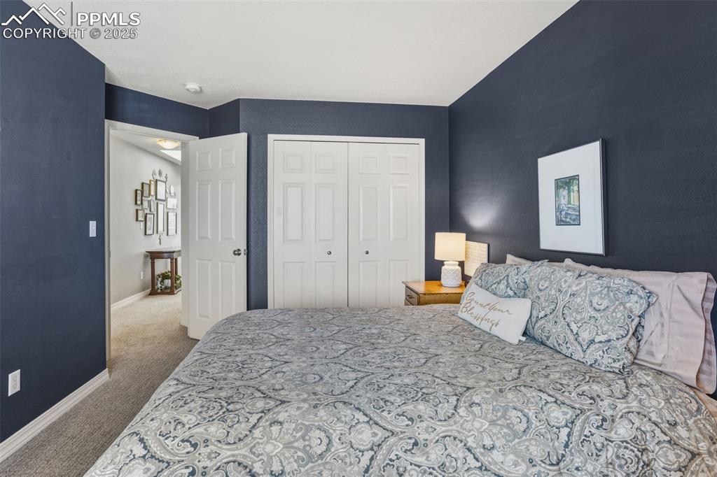 Bedroom featuring light carpet and a closet