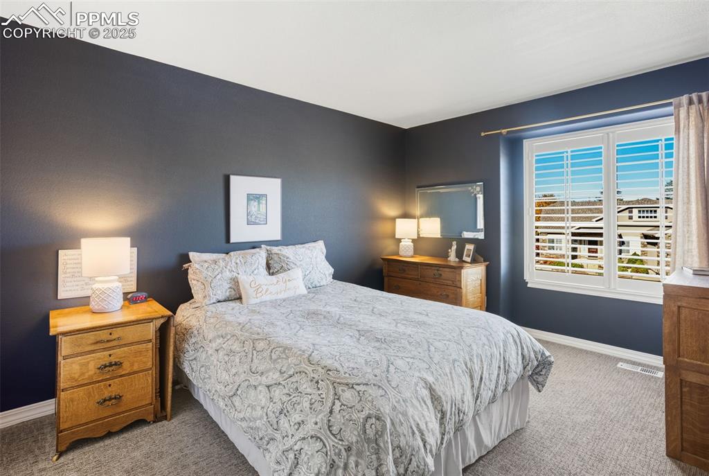 Bedroom featuring light colored carpet and baseboards